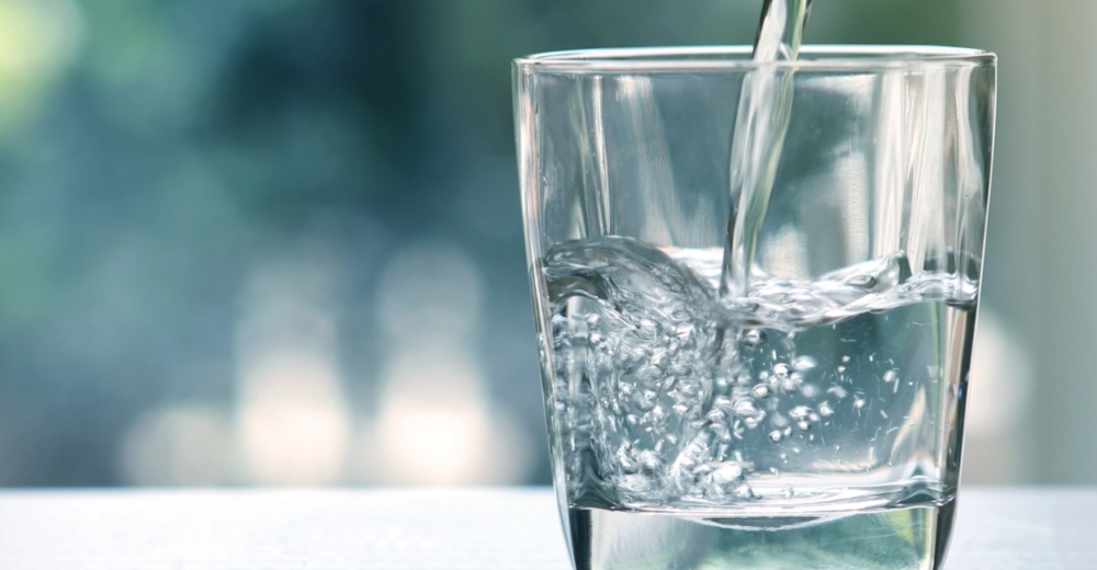 Glass of water filling up