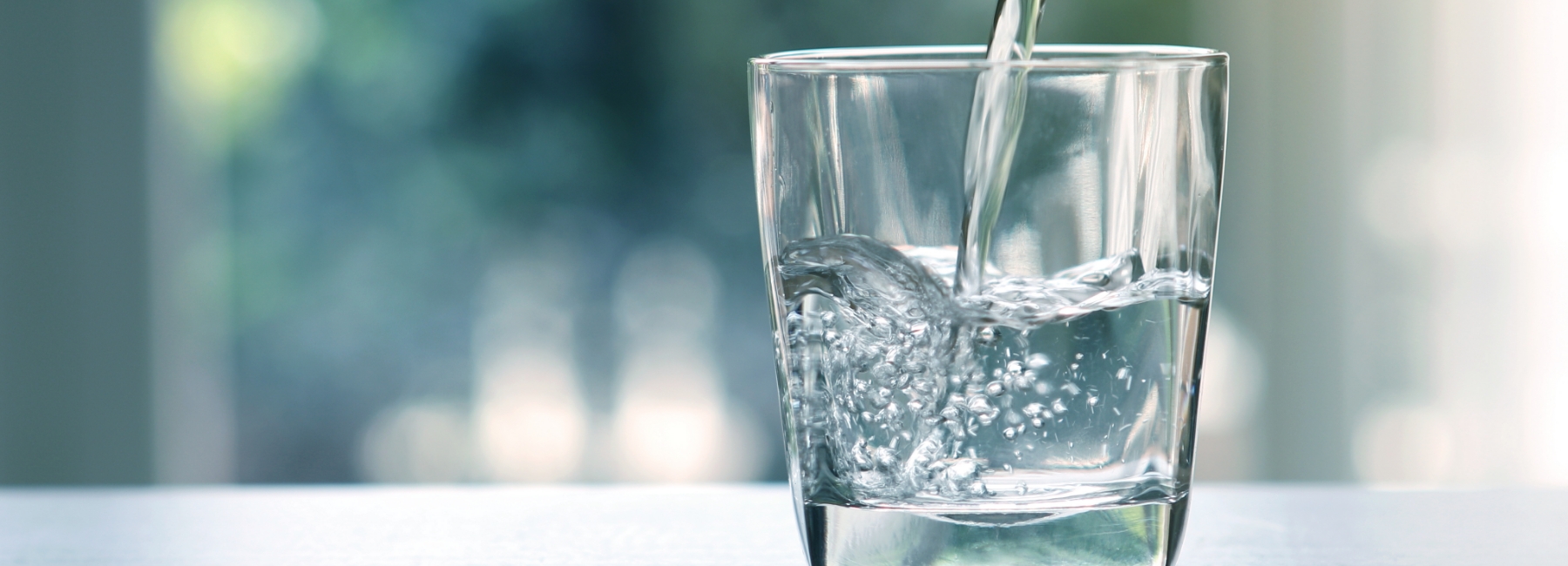 Glass of water filling up