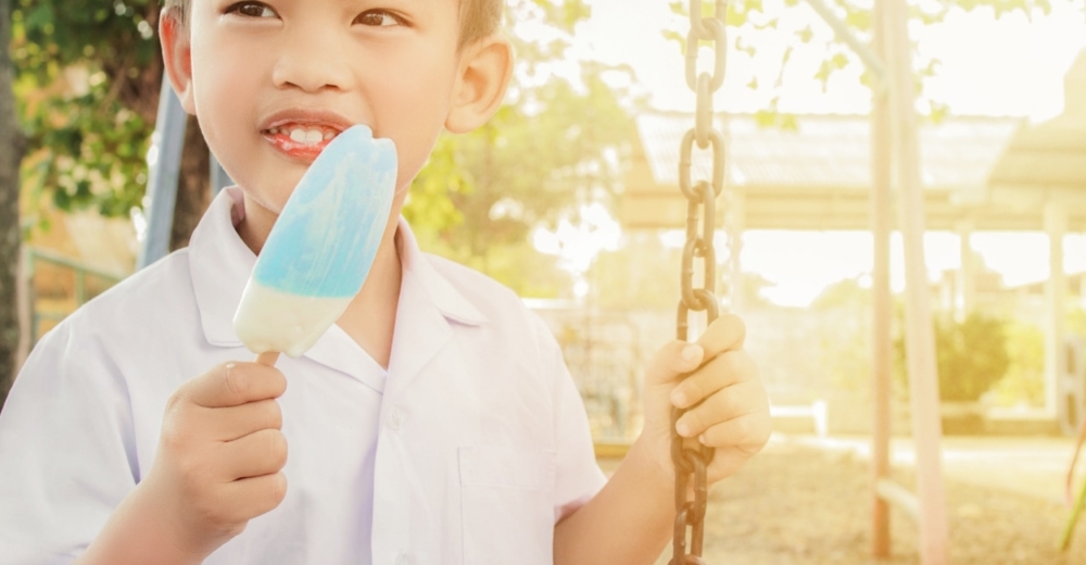 A child with an ice-cream on a seesaw