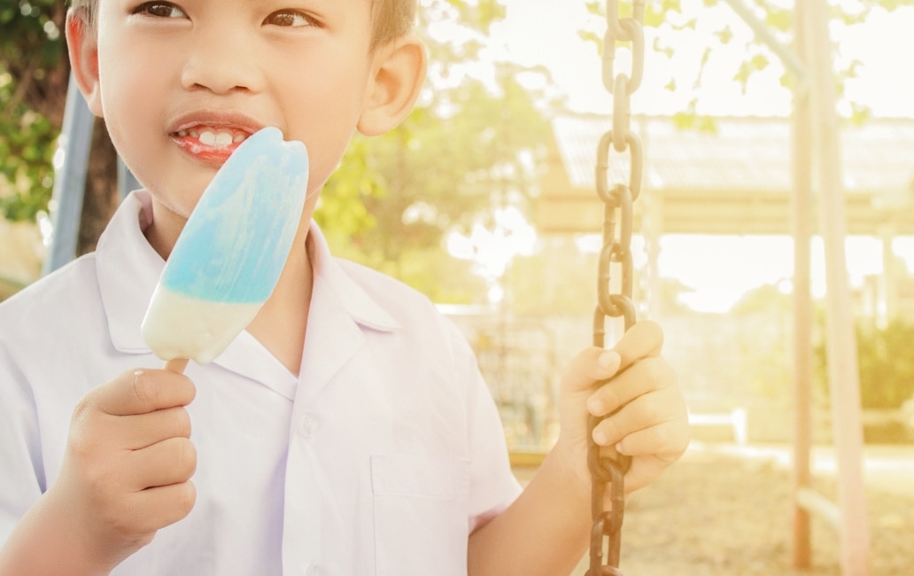 A child with an ice-cream on a seesaw