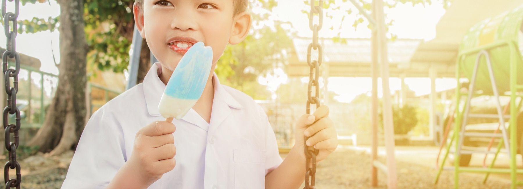 A child with an ice-cream on a seesaw