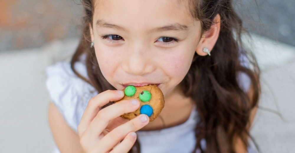 A girl eating a biscuit