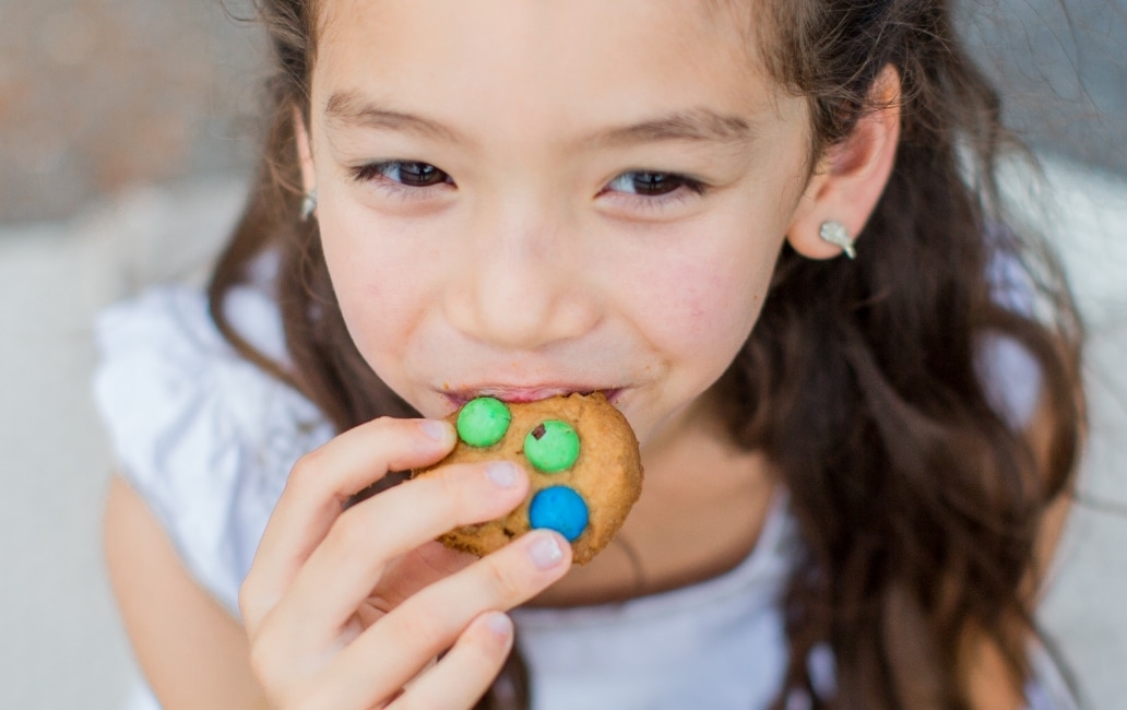 A girl eating a biscuit