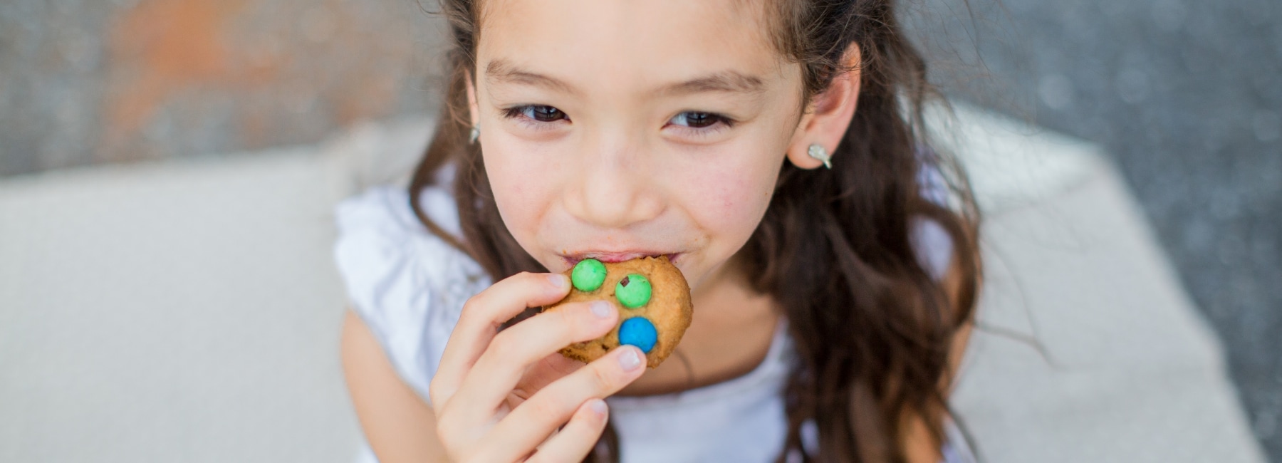 A girl eating a biscuit