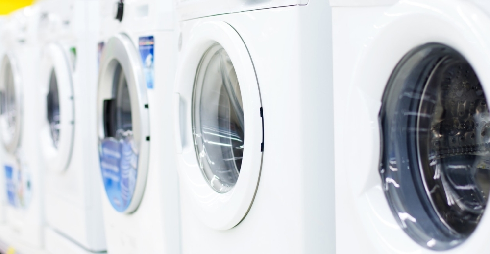 Several washing machines on display in a shop