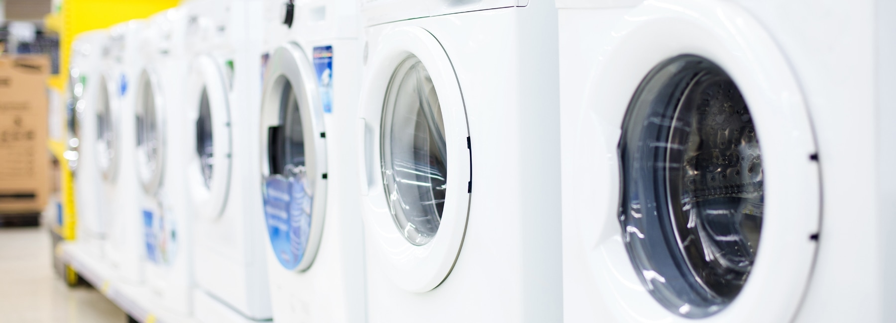 Several washing machines on display in a shop