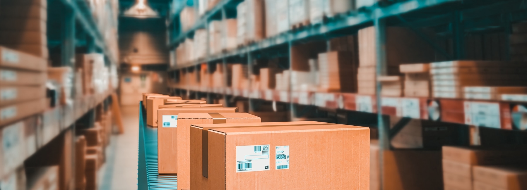 Warehouse with shelves with stored products and an aisle with cardboard boxes