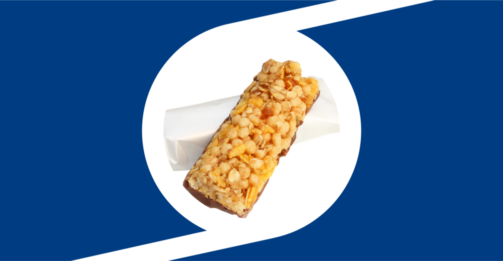 A granola bar placed on top of a blank white wrapper inside of the Taghleef monogram design element.